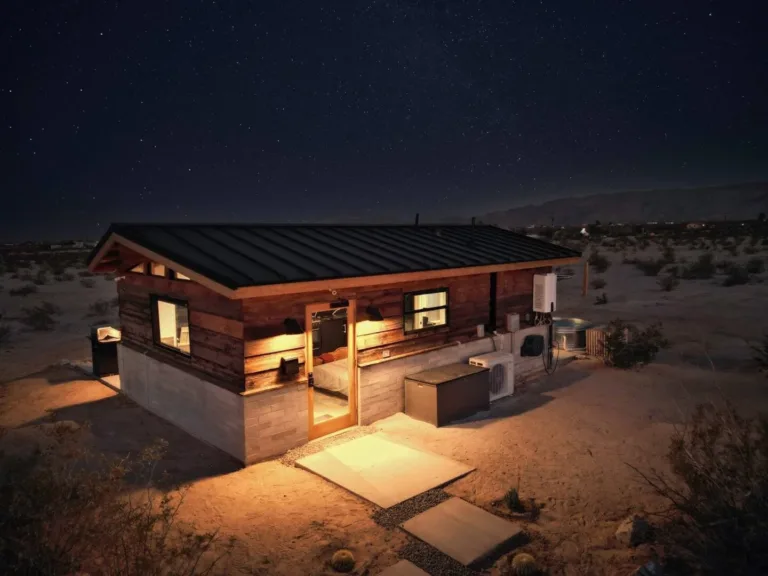 Modern rustic Joshua Tree Airbnb cabin (Clerestory style) with cowboy tub under starry night sky