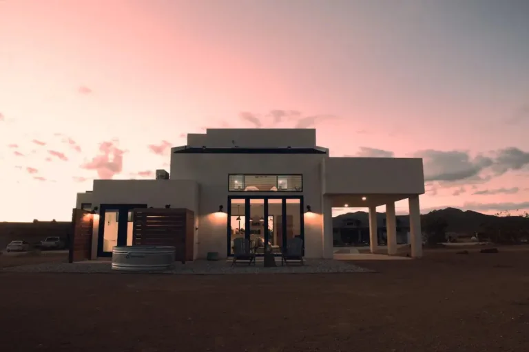 Modern Joshua Tree villa Airbnb (Soul Refuge style) with contemporary architecture and cowboy tub at dusk