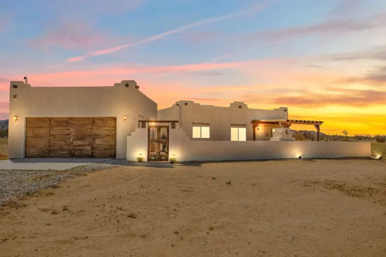 Authentic Adobe-style Joshua Tree Airbnb cabin exterior at sunset