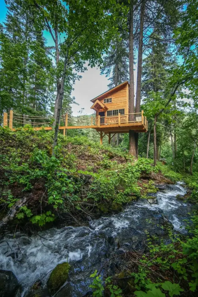 Hansel Creek Treehouse cabin rental perched above rushing creek in lush Washington forest, Peshastin