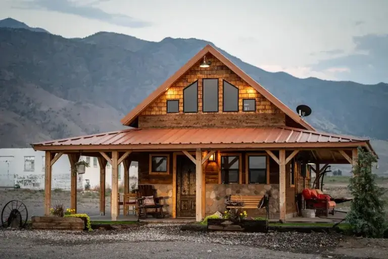 Rustic Unique Cozy Cabin rental exterior with wood details and wrap-around porch at the base of mountains in Monroe, Utah