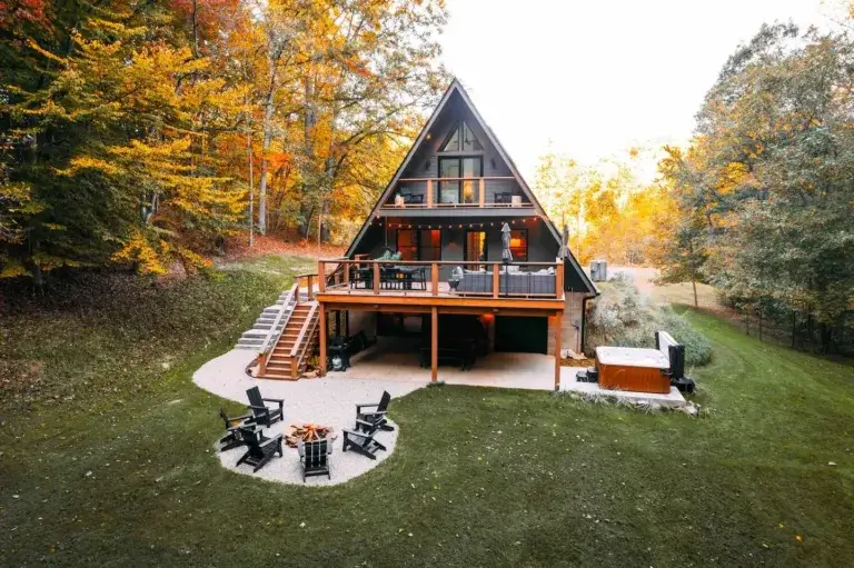 Wildewood A-frame cabin rental with decks, fire pit, and hot tub surrounded by autumn forest in Nelsonville, Ohio