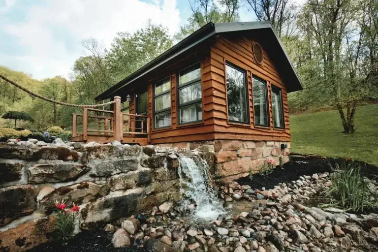 Cozy Pond Slider Studio cabin rental with adjacent man-made waterfall feature in Hocking Hills, Rockbridge, Ohio
