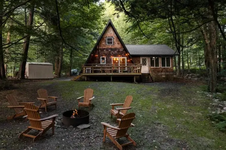 The Little A-Frame cabin rental by Camp Caitlin with large fire pit area in Greentown, Pennsylvania woods