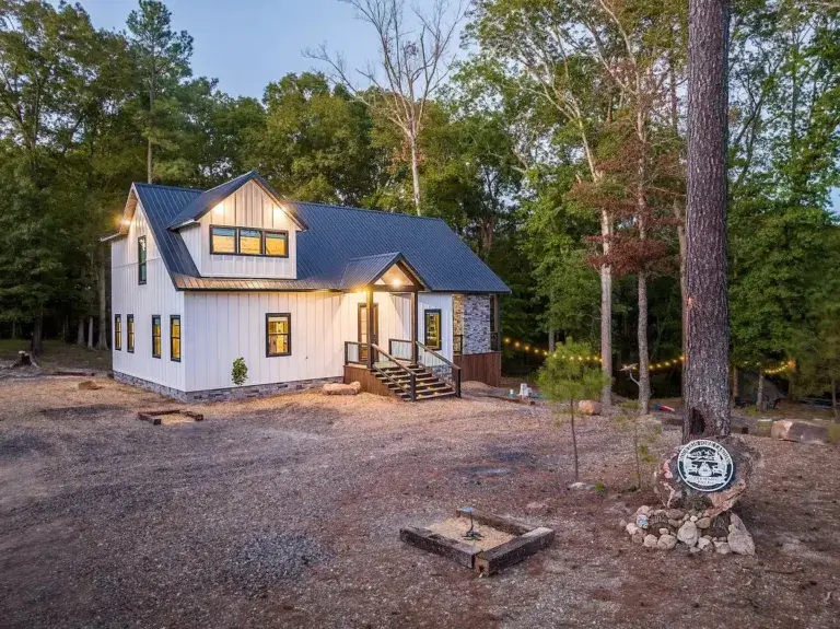 View from suspension bridge entrance towards elaborate Treetopia Treehouse rental in Broken Bow, Oklahoma forest