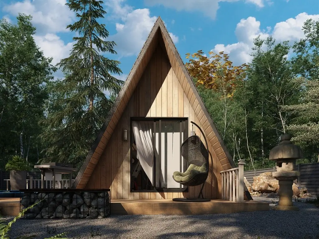 Charming Avrame SOLO+ A-frame tiny house kit with a welcoming porch in a lush forest setting.