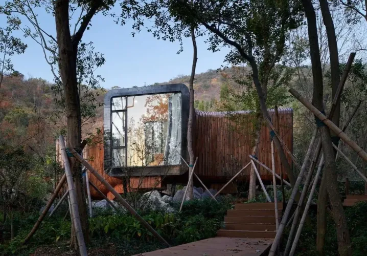 Spring Huts in China, modern cabins with distinctive curved wooden forms inspired by forest vines, elevated to preserve the natural landscape.