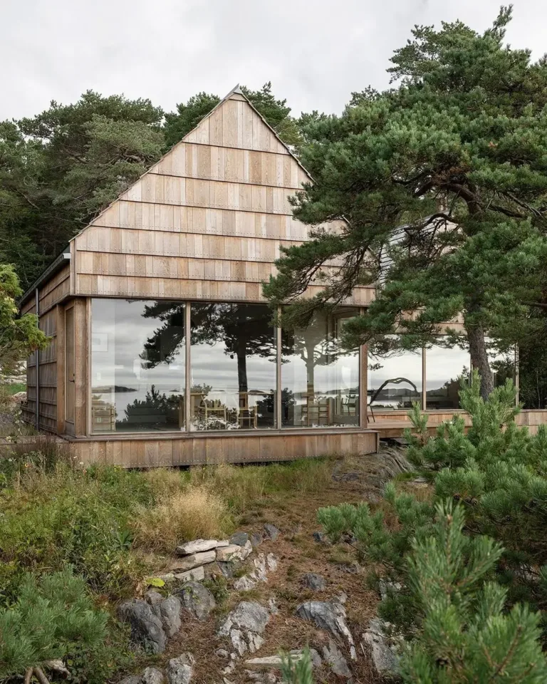 Unique house exterior clad entirely in recycled oak offcuts, showcasing a natural and sustainable Scandinavian approach.