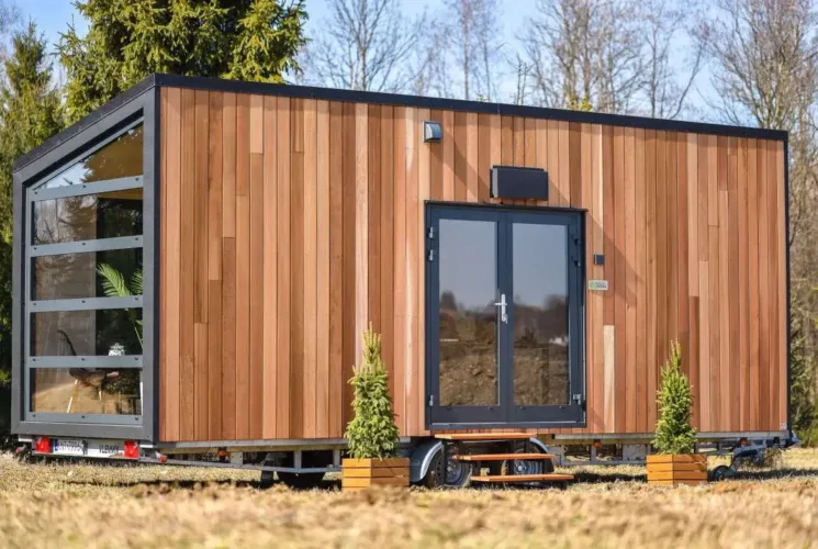 The Luna tiny home on wheels by Vagabond Haven, featuring a glass garage door, a modern prefab home for under 50k.