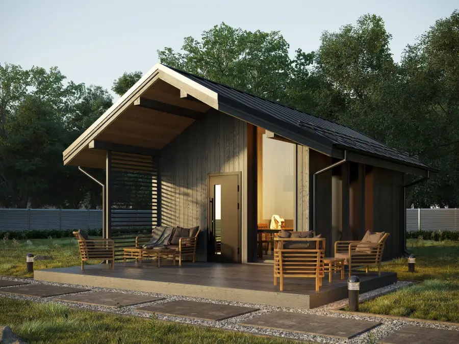 The Elva modular home by ILumhouse, featuring a modern cabin design with a covered porch, a prefab home for under 50k.