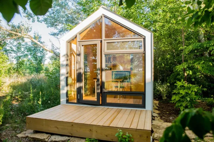 An ultra-compact tiny home with a full glass gabled front, a modern prefab bunkie for under 50k.