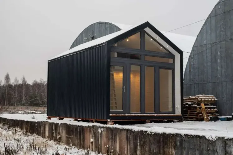 The Little Cabin with Loft by Spars AP, featuring a full glass front and metal siding, a modular home for under 50k.