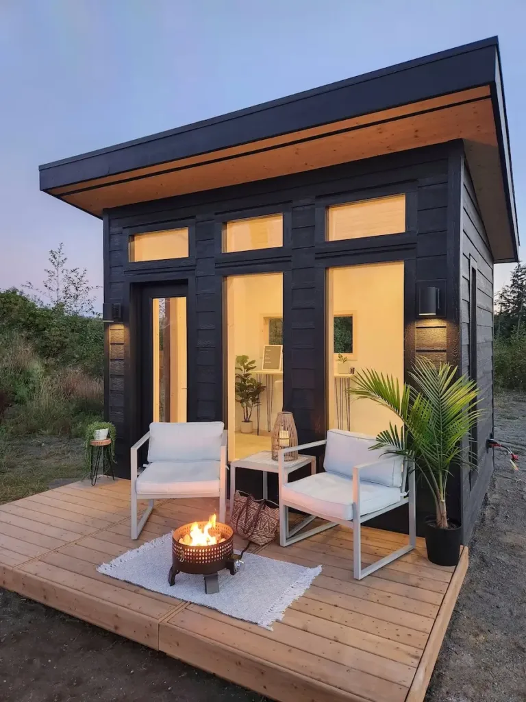 The Studio 10 Fir by Kubu, a black modern backyard studio with a deck, a prefab home for under 50k.