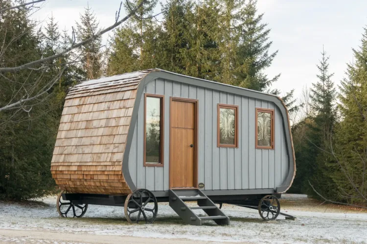 The Collingwood Shepherd Hut by Gute, with a curved roof and large wheels, a traditional prefab cabin for under 50k.