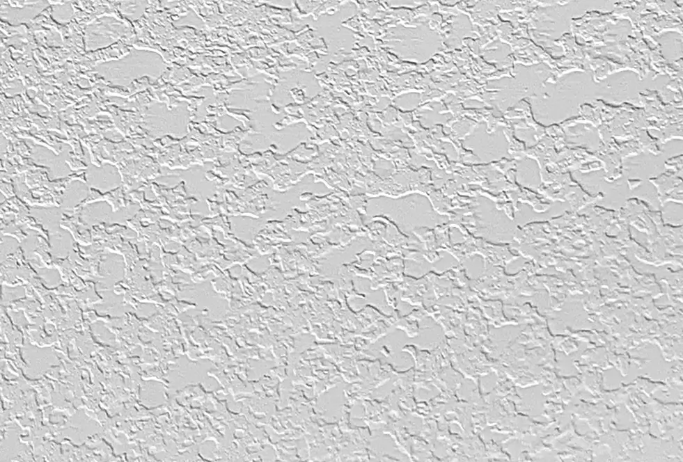 Delicate Spanish lace wall texture, a fine skip trowel variant, creating an intricate web-like pattern on a light-colored wall.