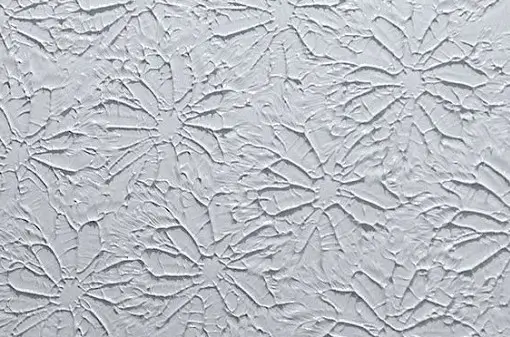 Unique slap brush wall texture, also known as crow's feet, creating a distinct sunburst pattern on a painted wall.