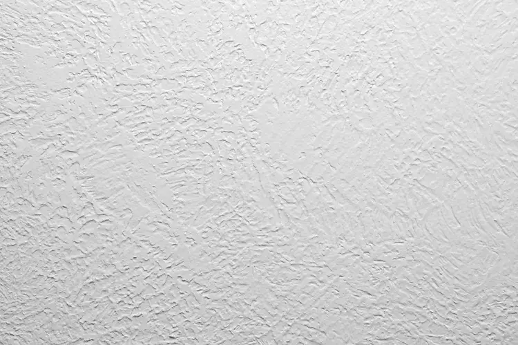 Rustic skip trowel wall texture in a warm white, illustrating a popular hand-applied wall finish for a Mediterranean style.