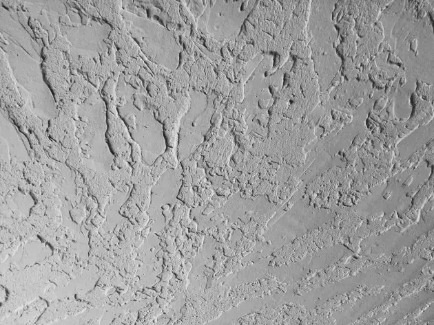 Authentic hawk and trowel plaster finish creating a rich, layered Old World wall texture in a deep gray.