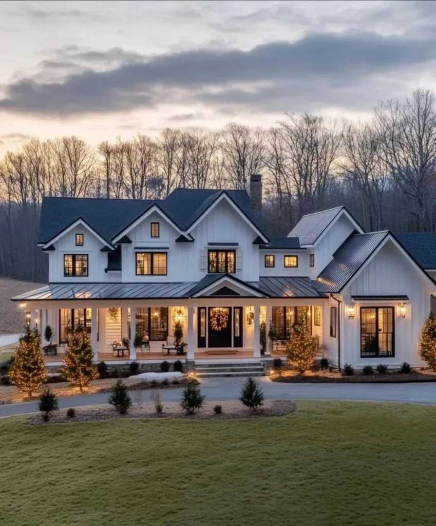 White farmhouse with black windows and trim, and a wrap-around porch