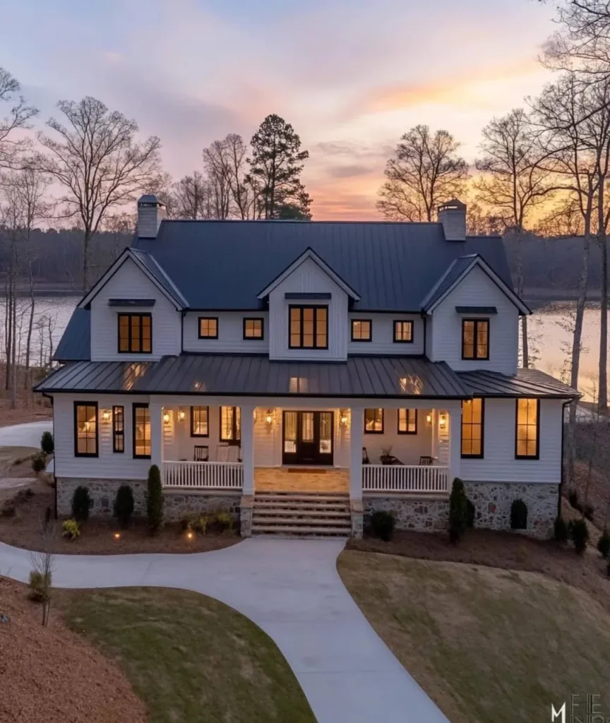 Modern farmhouse with a large porch and stylish exterior lighting