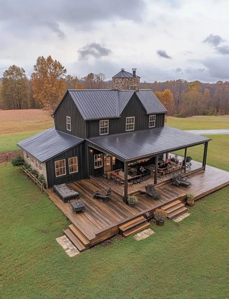 Modern farmhouse with a large, multi-level wooden deck and dark siding