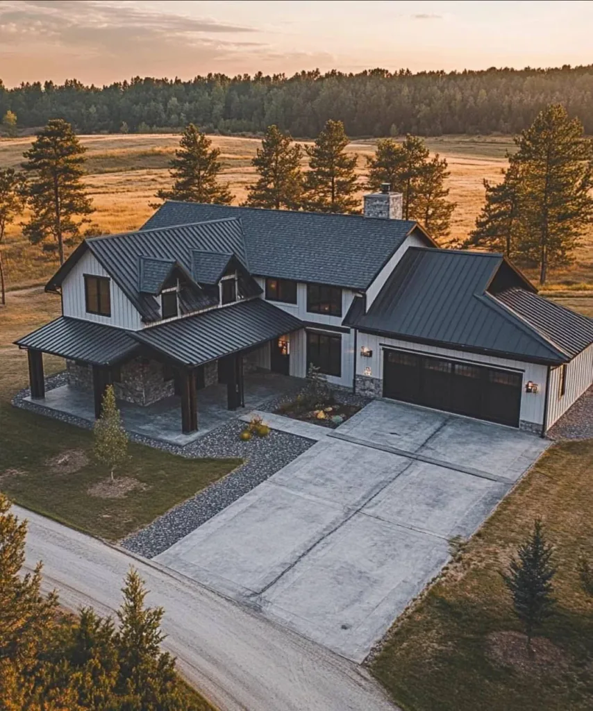 Modern farmhouse with a standing seam metal roof, mixed siding materials, and a large driveway