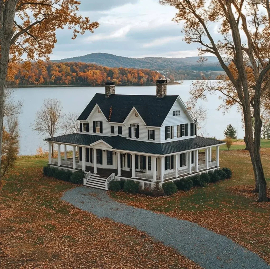 White farmhouse with wrap-around porch and black shutters