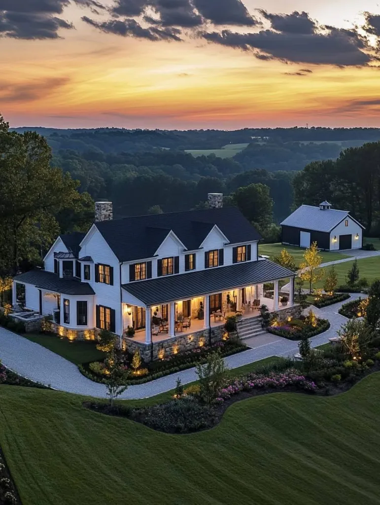 Farmhouse with a wide, circular driveway and landscape lighting