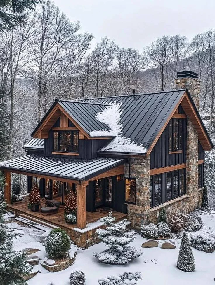 Farmhouse with stone exterior and snow-covered surroundings