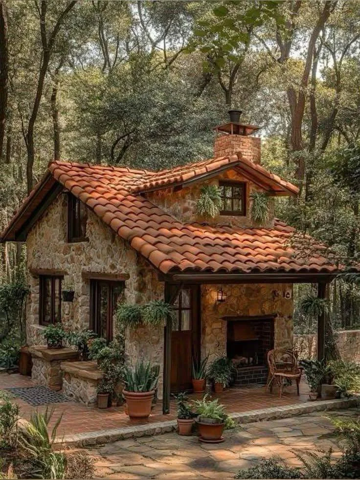 Small stone cottage with terracotta tile roof.