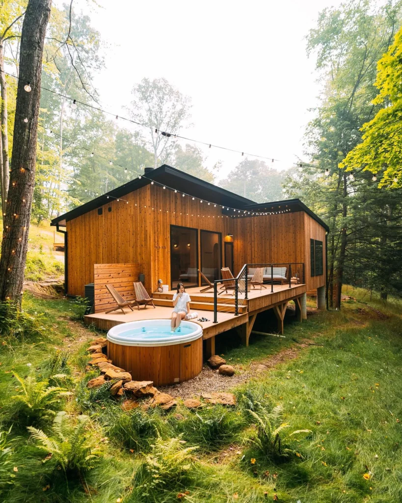 Dreamy cabin with wood siding, large deck, and hot tub.