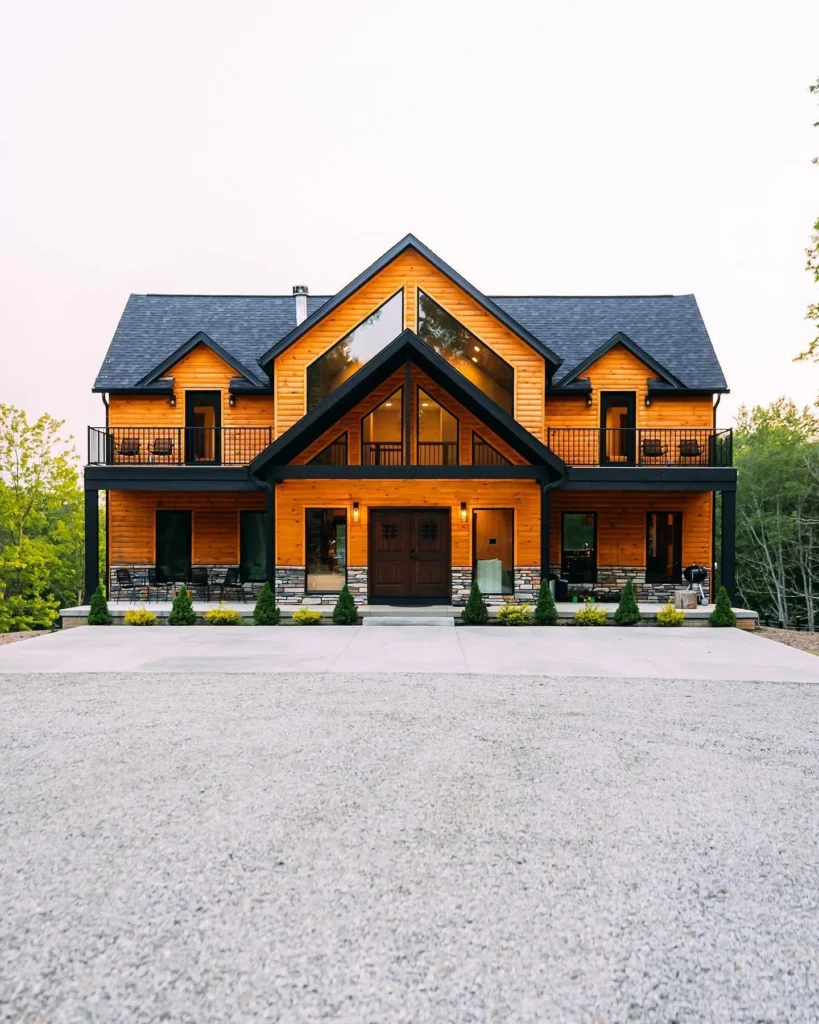 Dreamy large cabin with multiple balconies and warm wood tones.