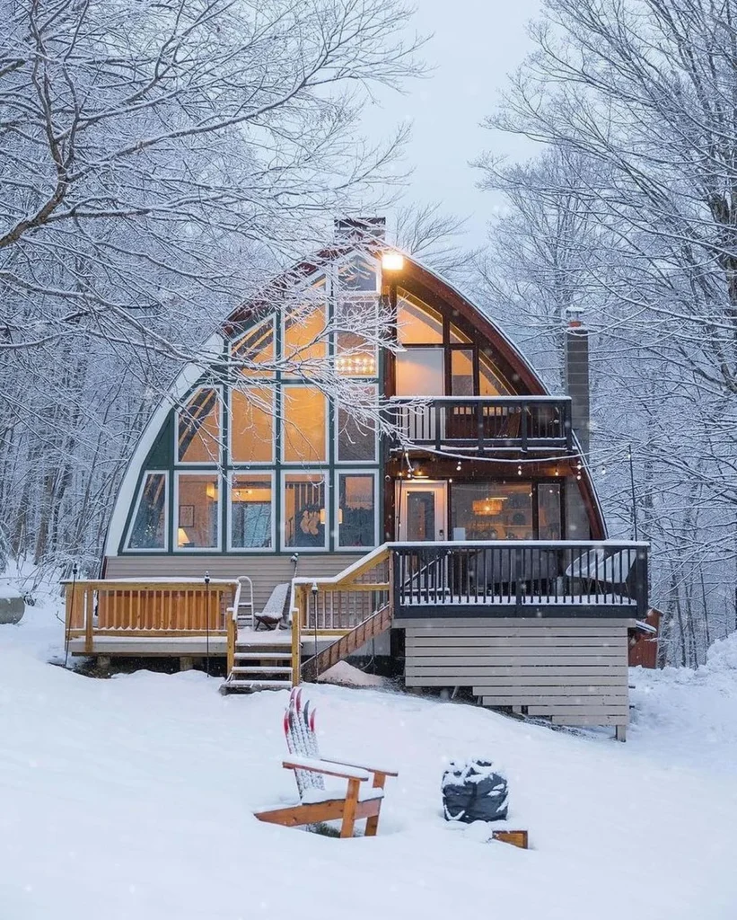 Dreamy cabin with a unique arched roof and large windows.