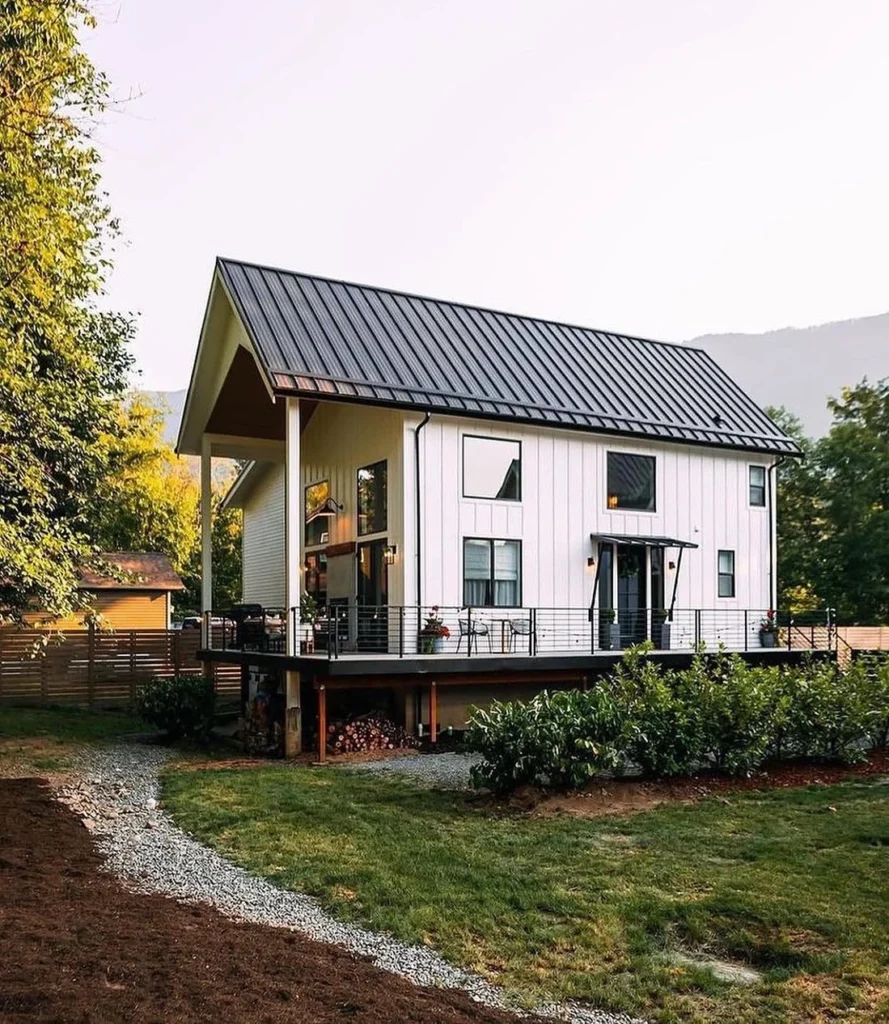 Dreamy white cabin with large deck and modern farmhouse style.