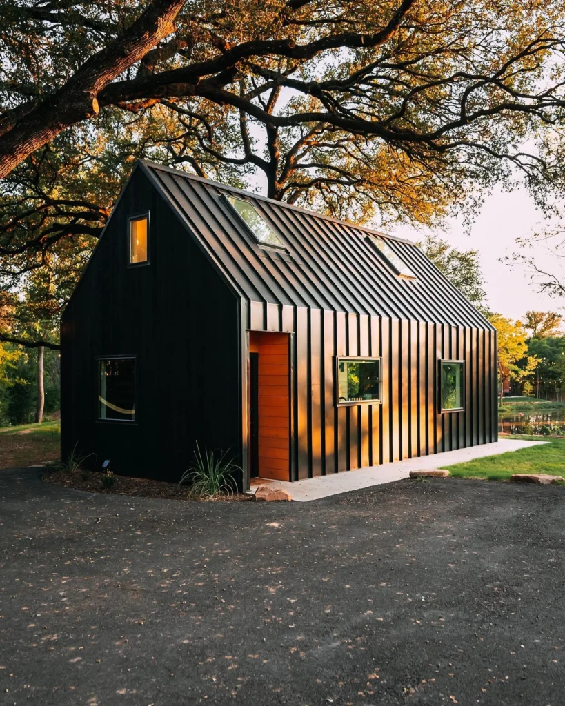 Dreamy modern cabin with dark metal siding and skylights.