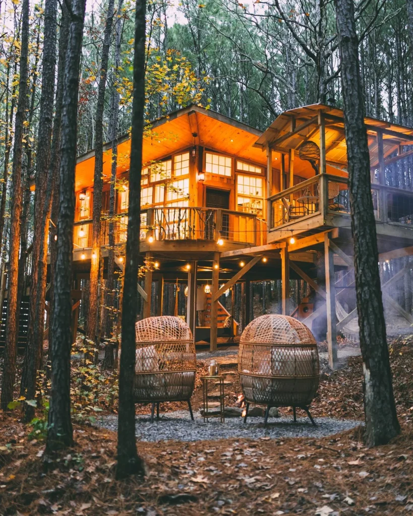 Dreamy multi-level cabin glowing in the forest.