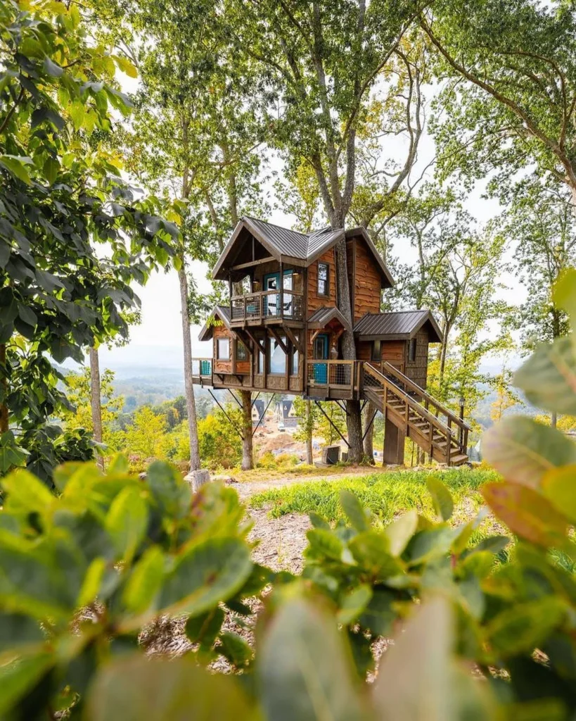 Dreamy treehouse cabin with panoramic views and multiple decks.