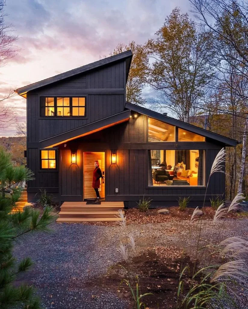 Dreamy dark-exterior cabin with large windows, glowing at twilight - Dreamy Cabin Getaways