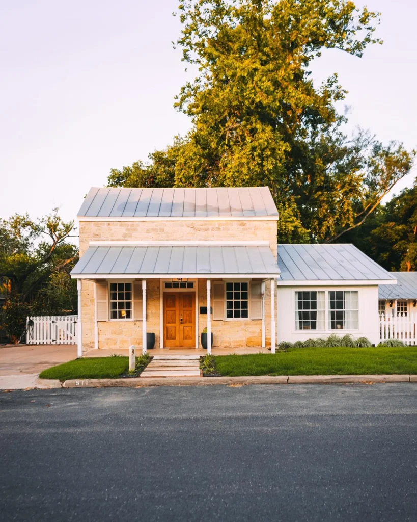 Dreamy cottage-style cabin with stone exterior and inviting porch.