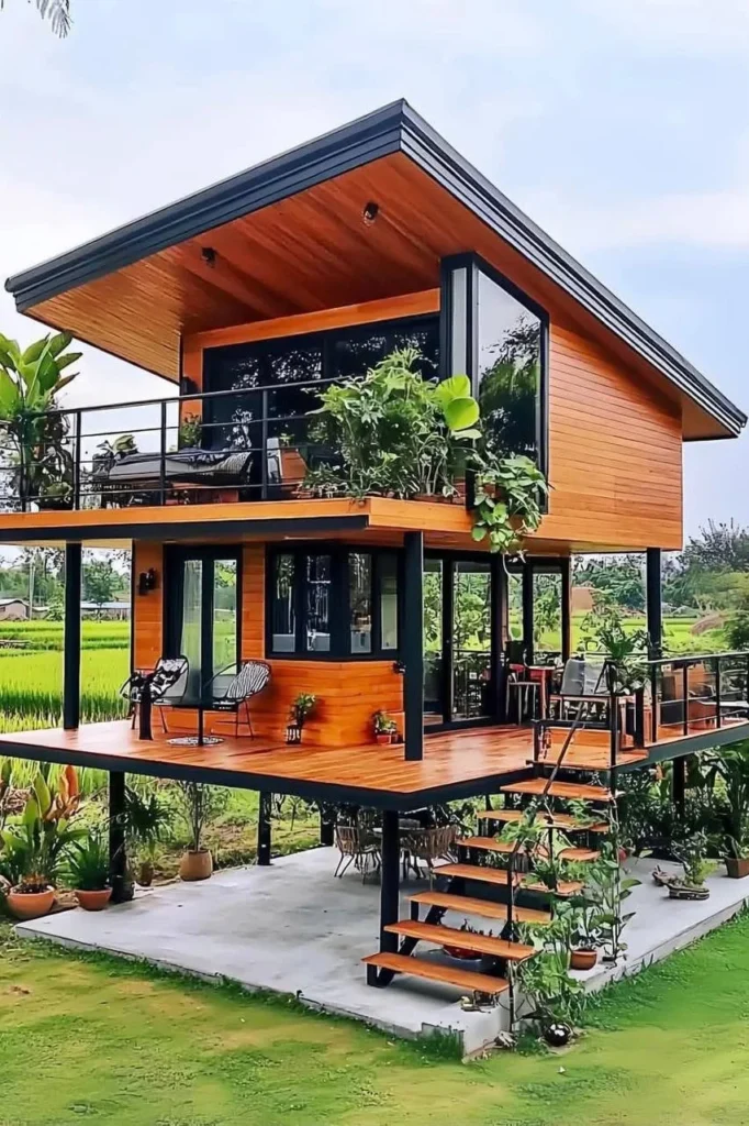 Two-story tropical wooden house with open balconies and modern design.