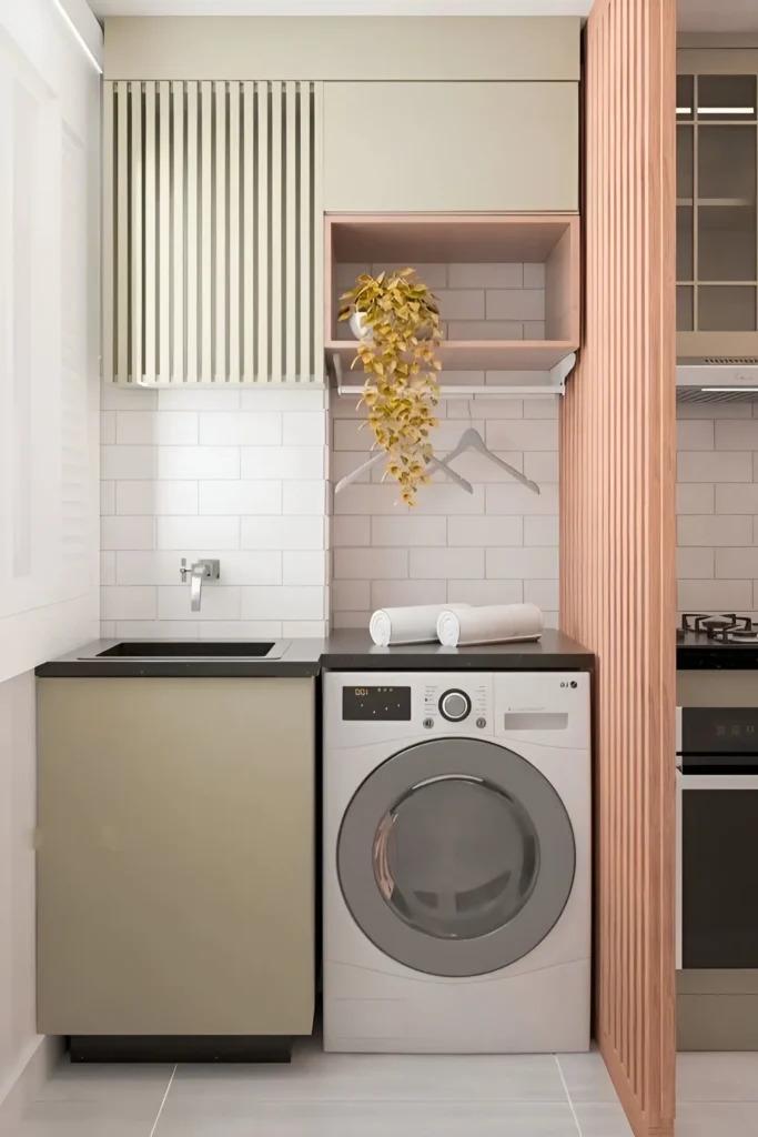 Narrow laundry space with washer, sink, mixed wall storage, hanging rod, and decorative partition.