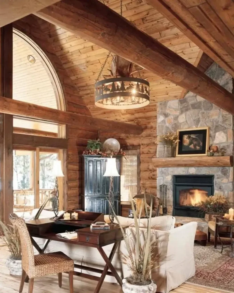 Natural stone fireplace in a rustic log cabin living room.