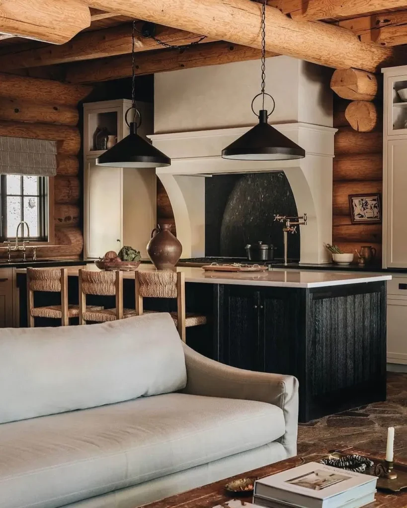 Open-concept log cabin kitchen and living room with natural wood and modern accents.
