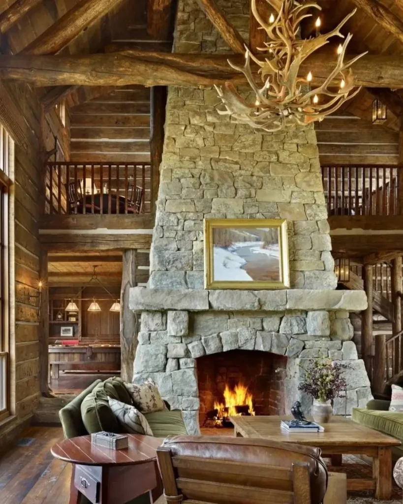 Grand log cabin living room with large stone fireplace and antler chandelier.