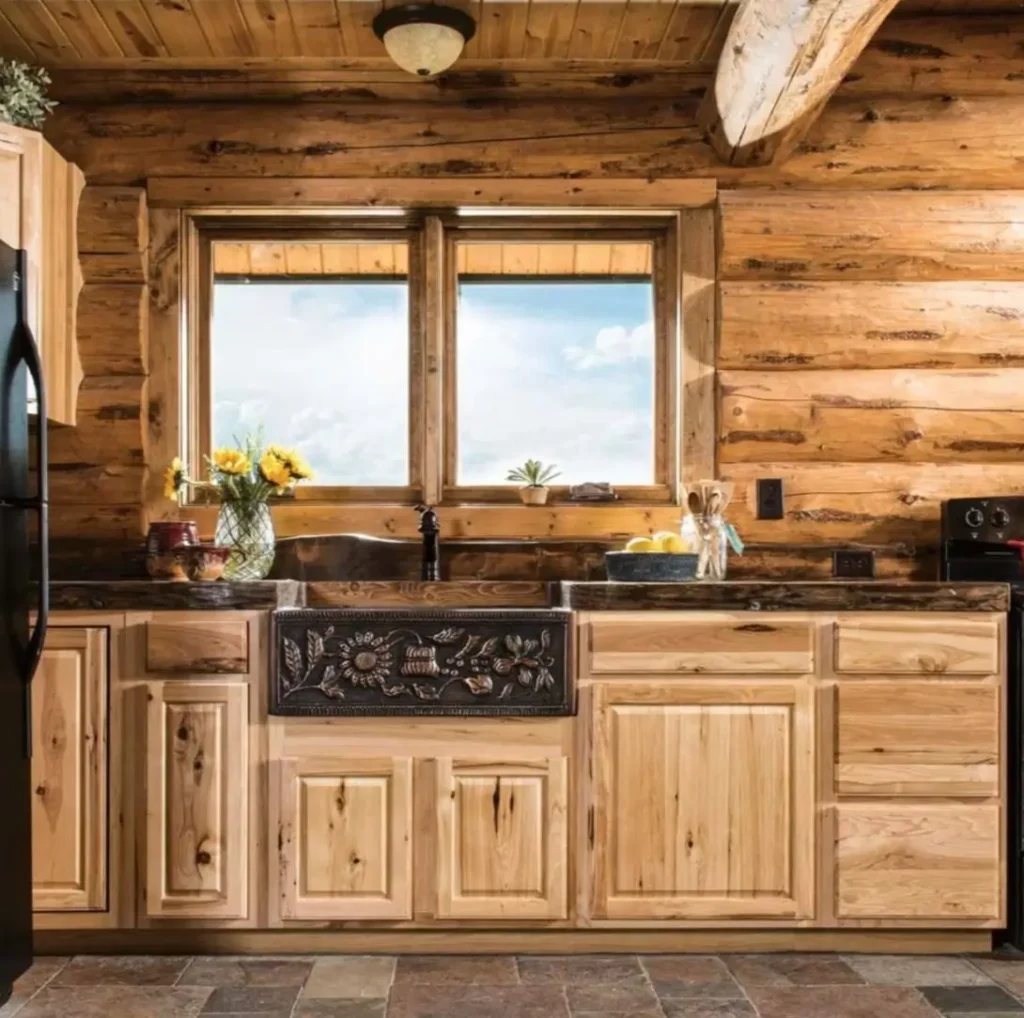 Log cabin kitchen with a unique floral motif sink and wooden cabinetry.