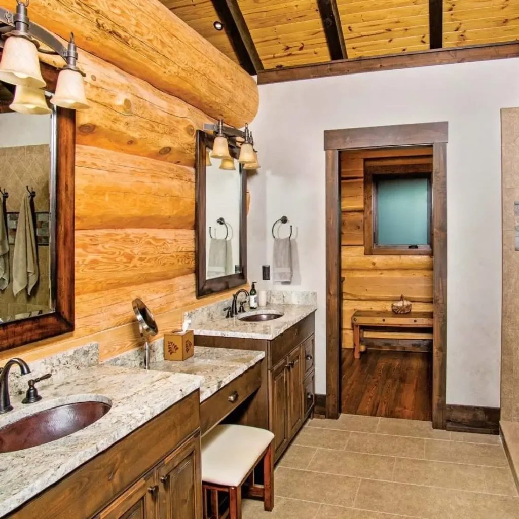 Log cabin bathroom with dual vanity sinks, wood cabinets, and exposed logs.