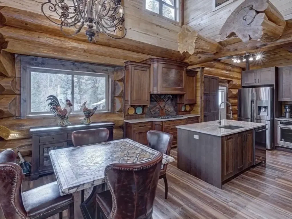 Cozy log cabin interior featuring a grand kitchen, rustic wood, and modern design elements.