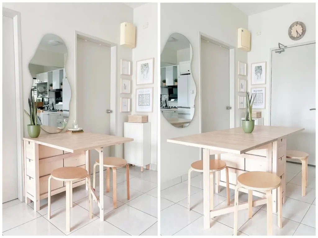 A light wood drop-leaf table in a dining nook, a key small apartment decorating idea on a budget.