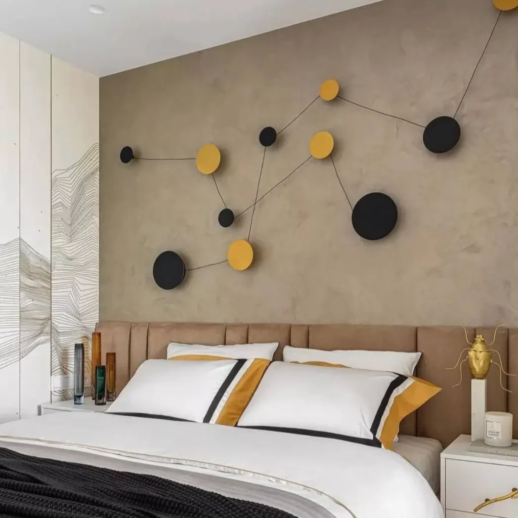 A modern bedroom with abstract 3D wall art above the headboard, a unique small apartment design idea on a budget.