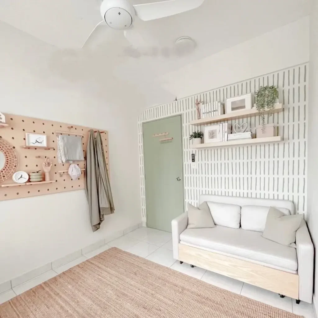 A bright guest room with a stylish daybed, demonstrating a simple small apartment decorating idea.